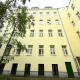 saniertes Altbauhaus, gelbe Fassade, weiße Fenster, Innenhofblick , links 3 Laubbäume, Wohnung im 12. Bezirk Wien